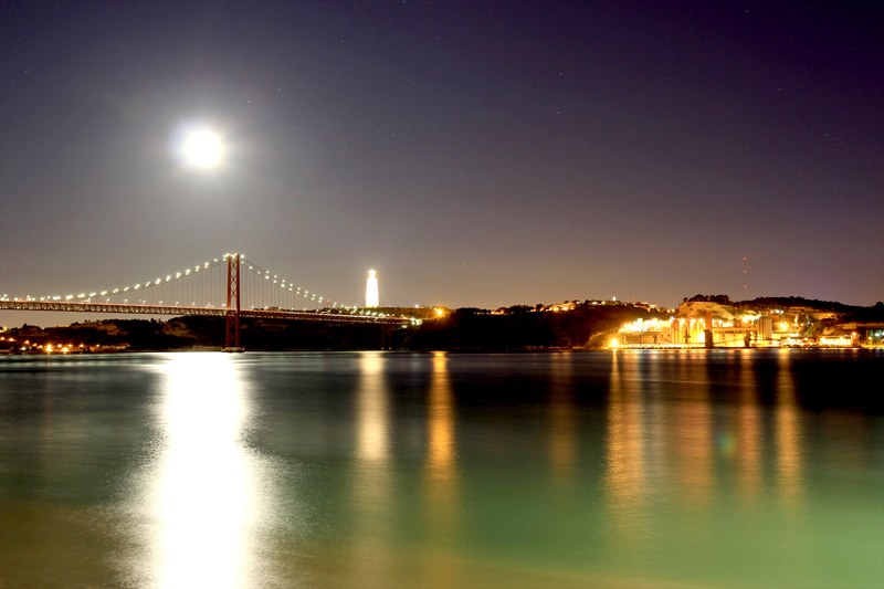 Night Photography of the Tage in Lisbon Portugal with beautiful color reflection